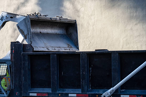 a construction work zone with dirt being dumped into a dump truck